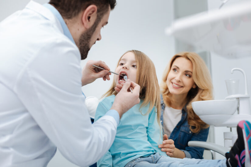 Family dentist checking teeth